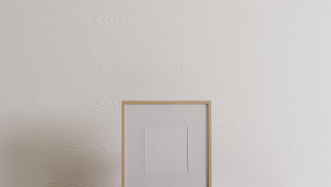 Wooden-frame-with-copy-space-on-white-background-and-white-wall