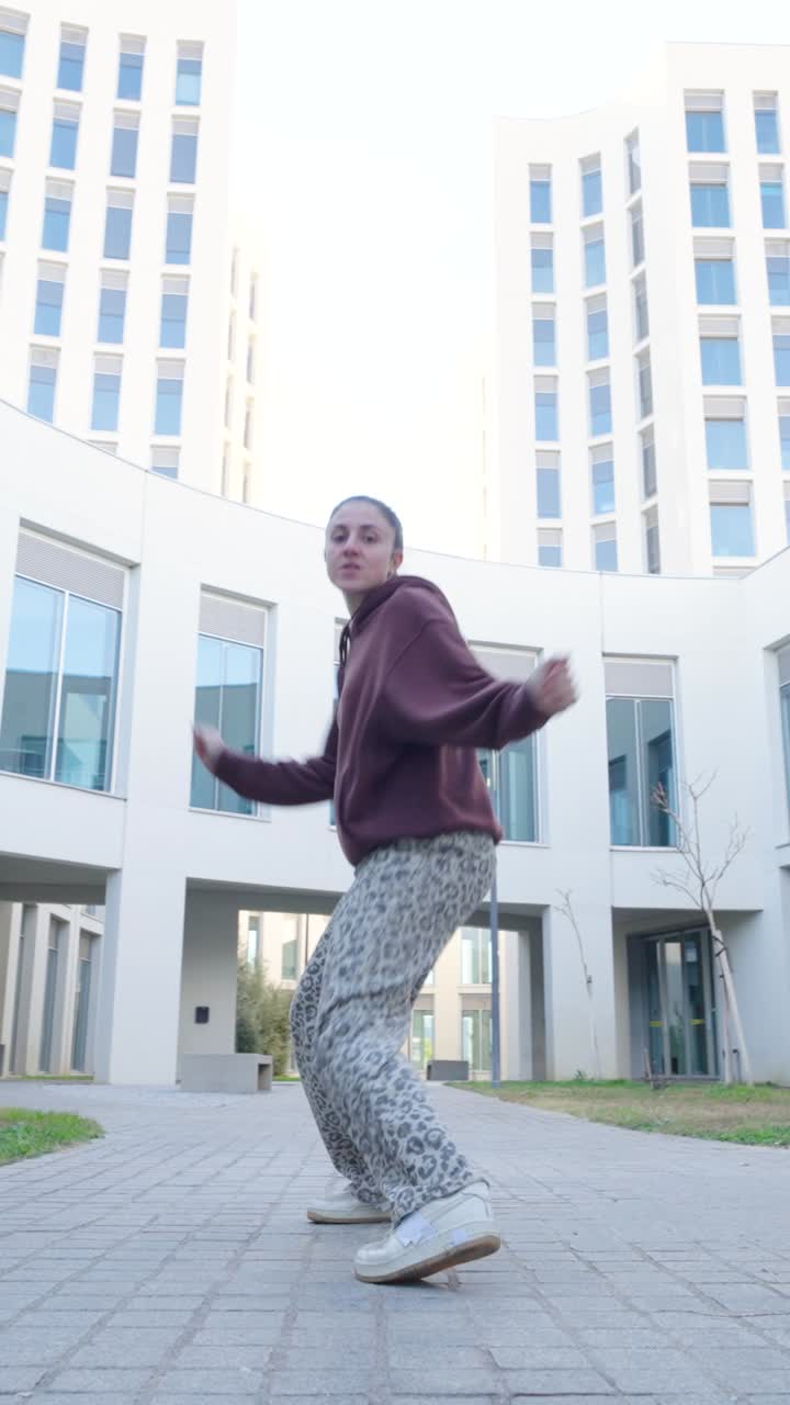Young urban dancer performing breakdance moves outdoors