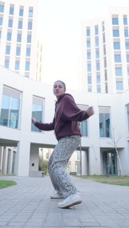 young urban dancer performing breakdance moves outdoors
