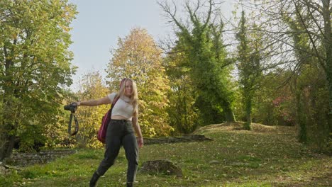 Beautiful-woman-funny-playful-moment-for-camera-autumnal-backdrop