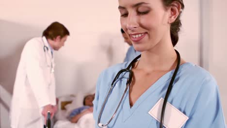 portrait of a nurse writing on her clipboard