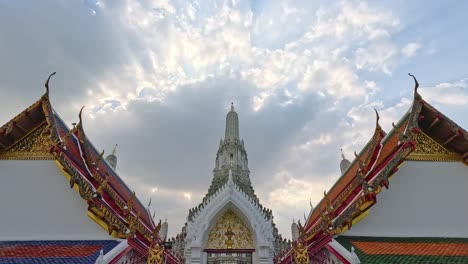 scenic view of wat arun temple with dramatic cloudy sky backdrop