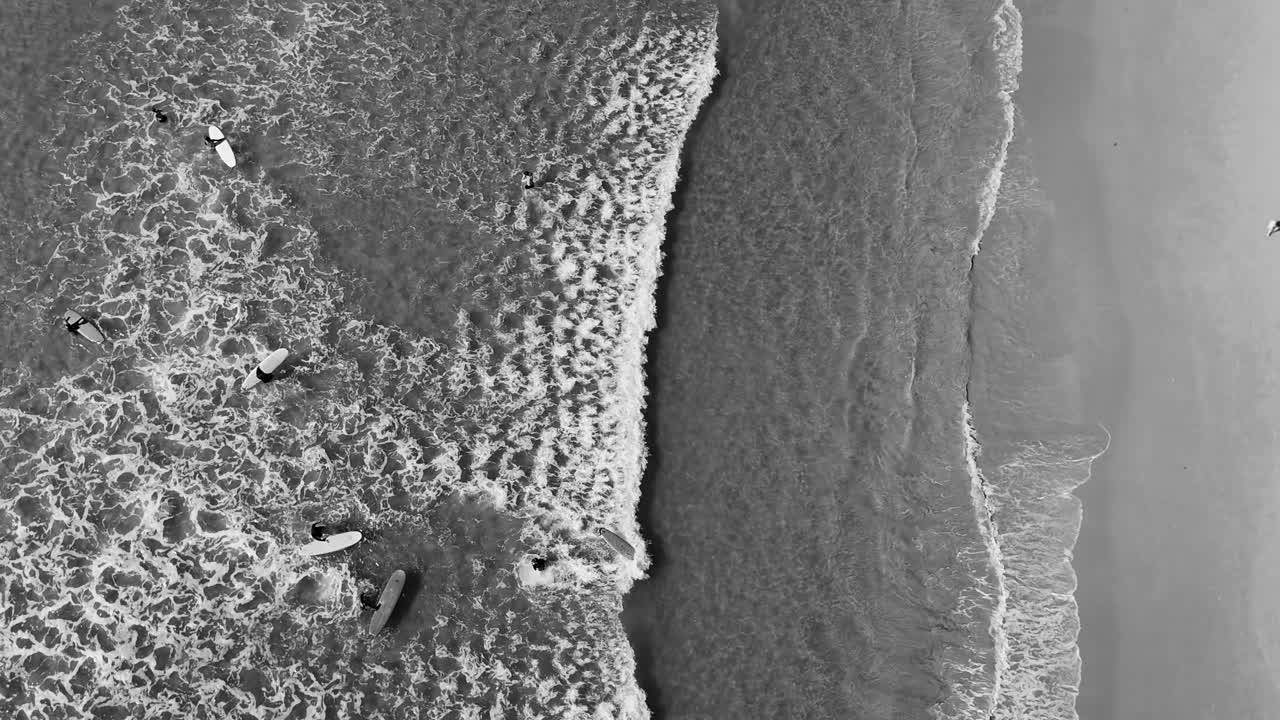 Aerial views of beaches and surfers in black and white