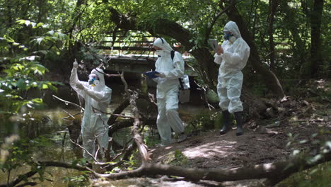 environmental researchers conducting water quality test in a forest