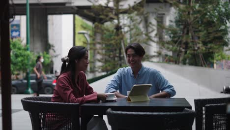 Couple having coffee and a meeting outdoors