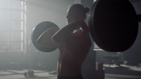 guy lifting weights. male bodybuilder doing crossfit training with barbell