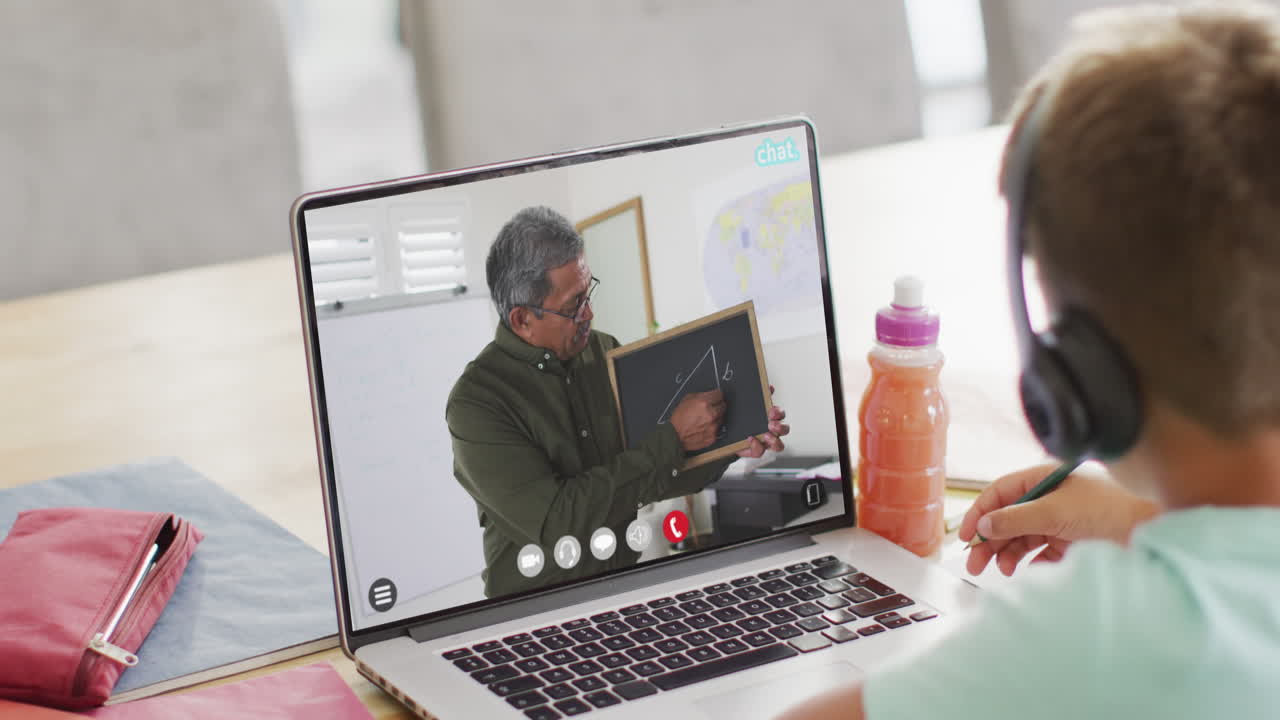 Composition of caucasian boy on laptop online learning with biracial male teacher