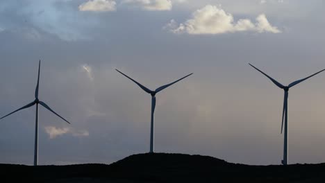 group of windmills for renewable electric energy production. production of green energy with wind and mills to stop global warming and start a better environment future planet. concept of save earth