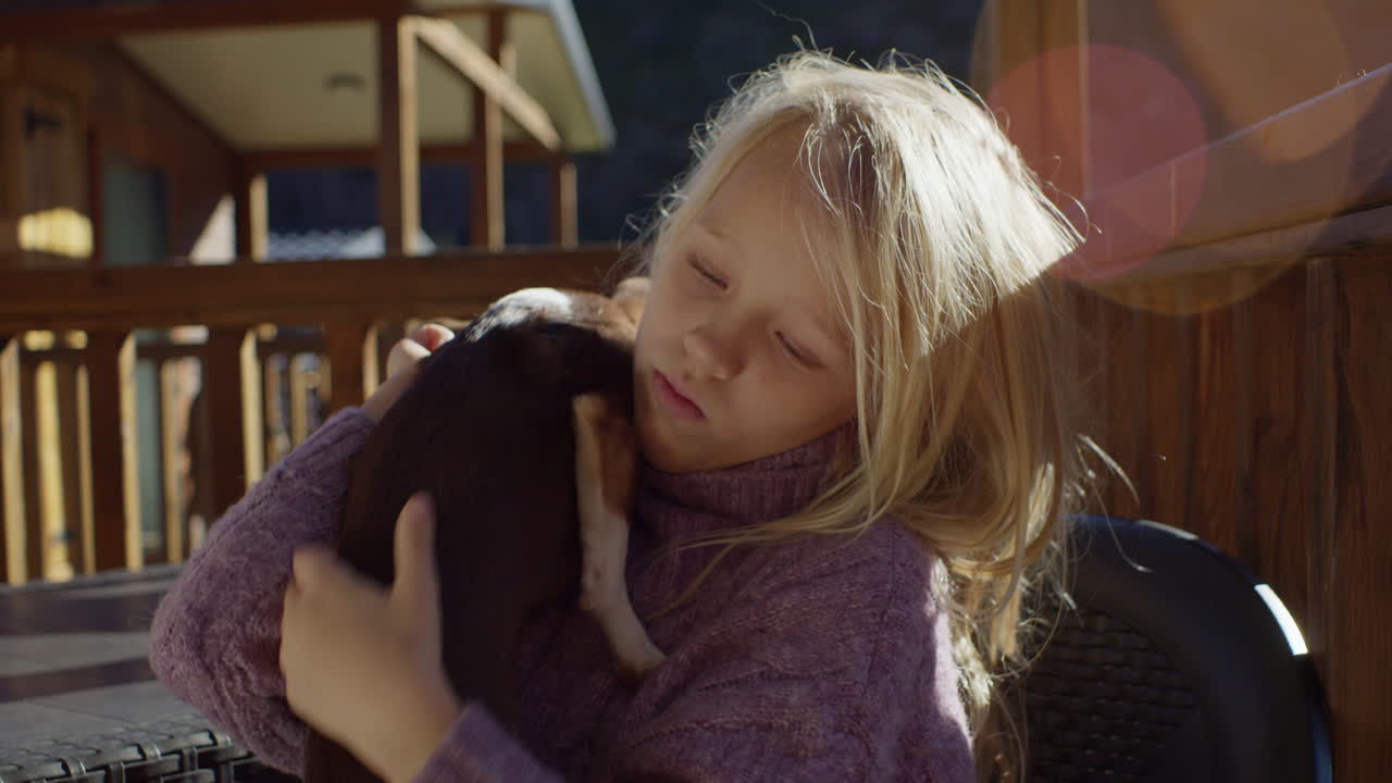 Girl Hugging a Chihuahua on a Patio