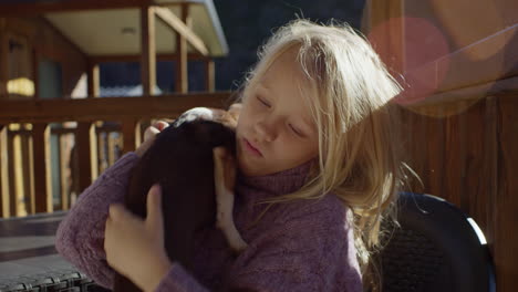 girl hugging a chihuahua on a patio