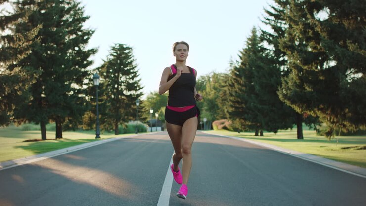 Sport woman running in park. Fitness girl training outdoor. Runner woman