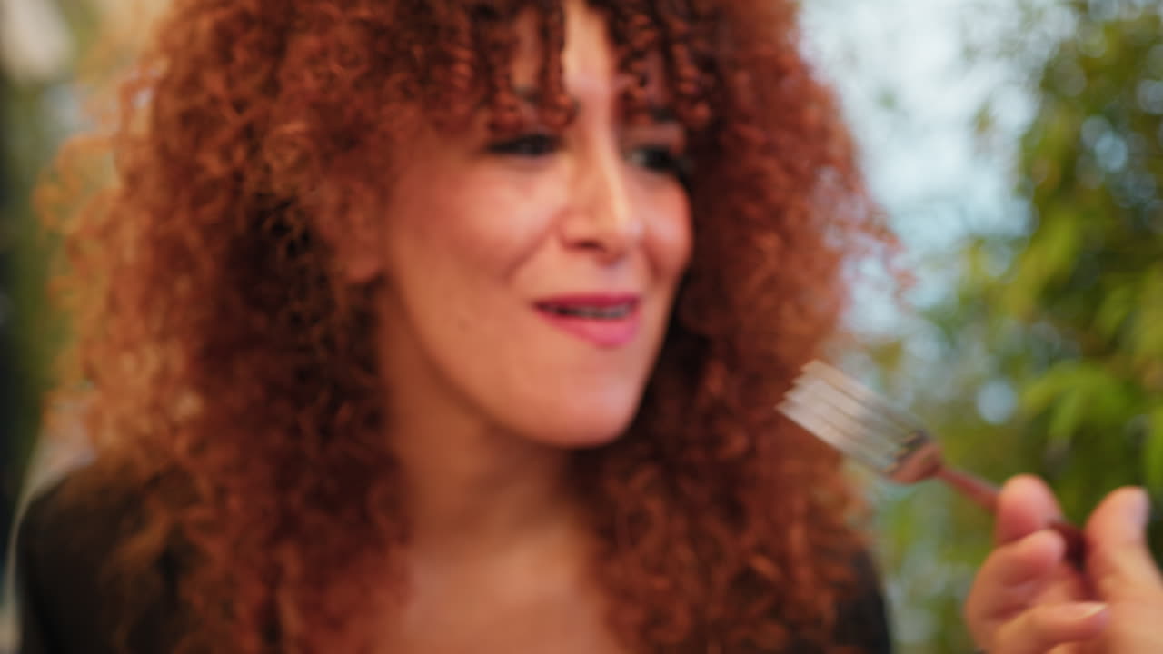 During Dinner A Woman Eating A Mussel From Her Boyfriend Fork