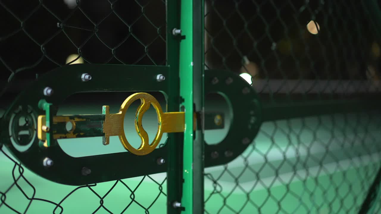 Empty and closed tennis court by night in London in the UK, lit up by street lights, during the Covid-19 Coronavirus pandemic lockdown