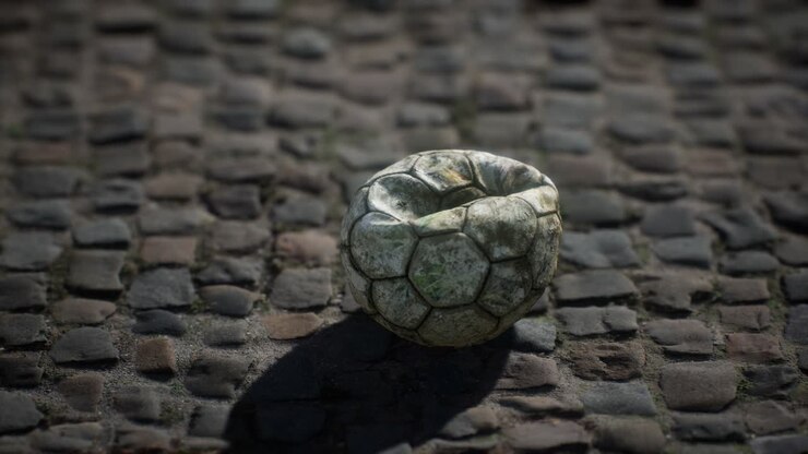 Old soccer ball in the pavement yard