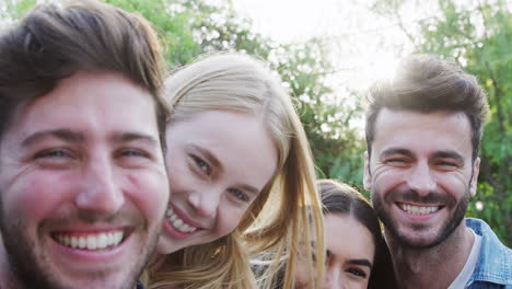 portrait of group of multi-cultural friends enjoying outdoor summer garden party