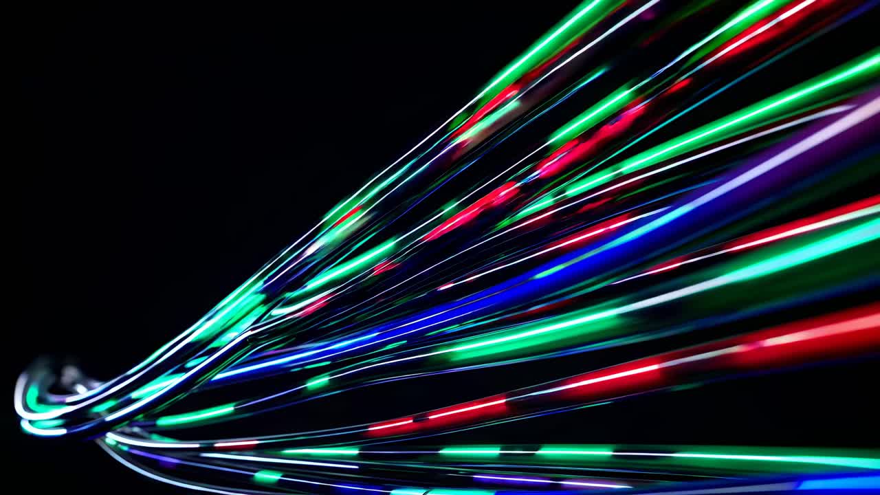 Dynamic video concept of colorful light trails on a black background, captured from a low-angle
