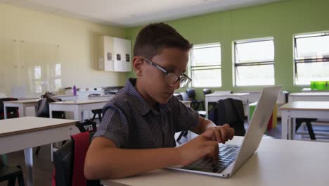 Boy-using-laptop-in-the-class