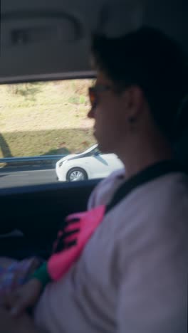 person looking out car window on a road trip