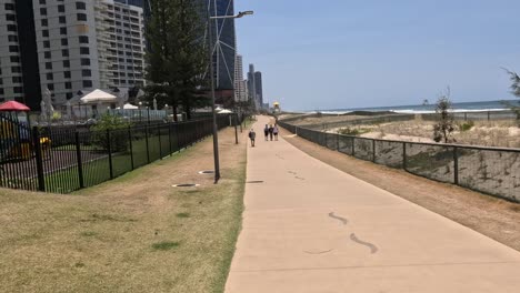 people walking along a coastal urban path