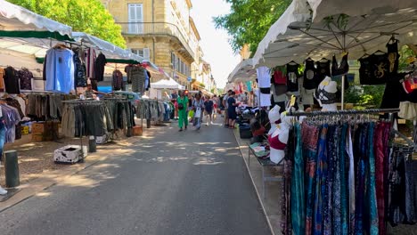 vibrant street market with clothing stalls