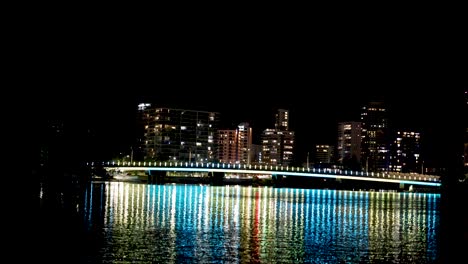 city lights reflecting on water at night