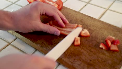 Cutting-Paprika-on-wooden-board-in-kitchen,-normal-speed