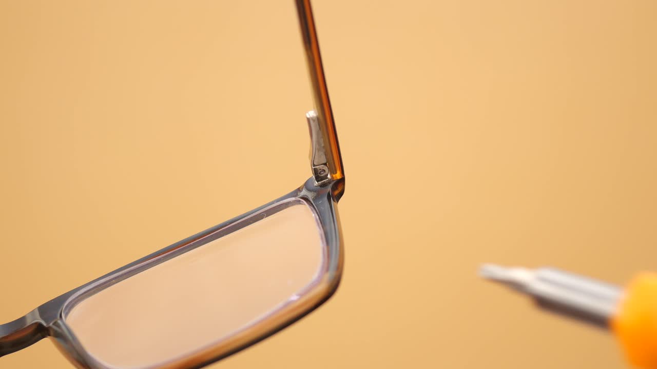 Repairing eyeglasses with a small screwdriver