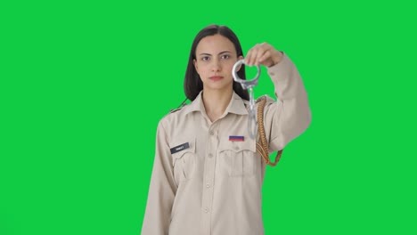 Indian-female-police-officer-posing-with-handcuffs-Green-screen