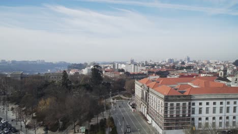 Downtown-Porto-old-city-center-streets,-business,-commerce-and-high-rise-buildings-on-sunny-day,-Portugal,-handheld-pan-right