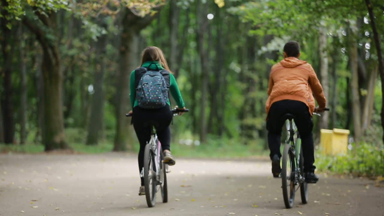 Couple Riding On Bicycles. Happy couple riding bicycle outdoors together