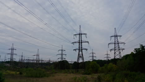 high voltage electrical substation over sunset background with transformers.