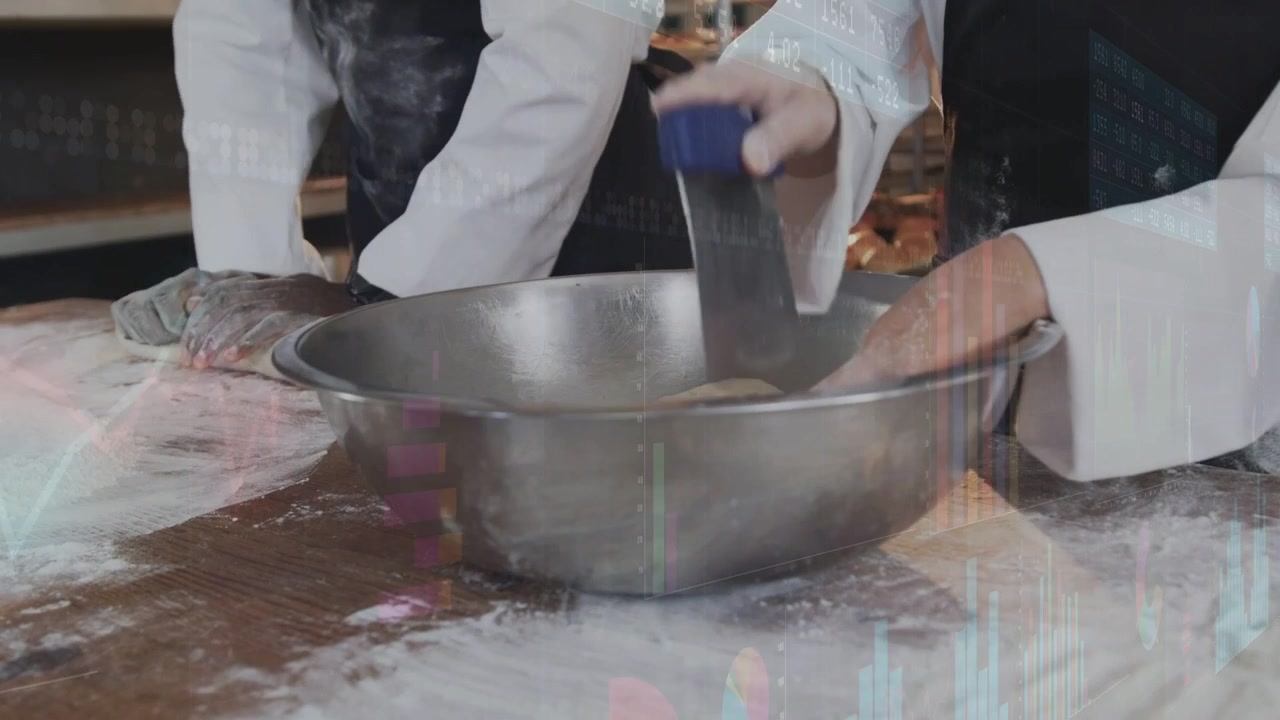 Two bakers pressing dough on bakery bench, right baker scraping bowl, forming portions for baking