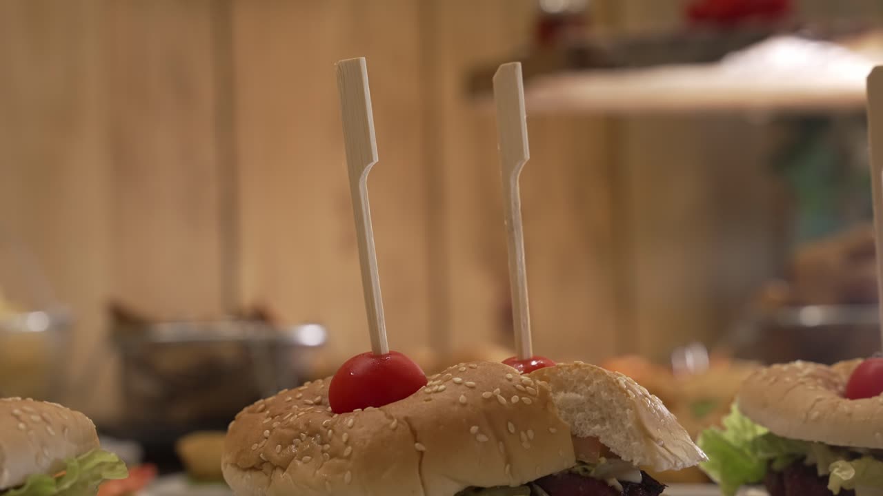 Gourmet sandwiches displayed with lettuce ham and cherry tomato garnish