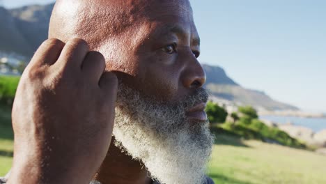 senior african american man exercising putting earphones in