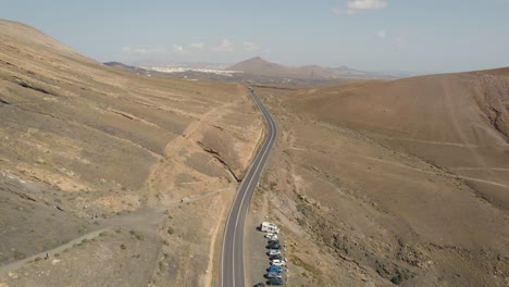 Aerial-View,-Scenic-Las-Grietas-Road-in-Volcanic-Landscape-of-Lanzarote,-Canary-Islands-Spain,-Drone-Shot
