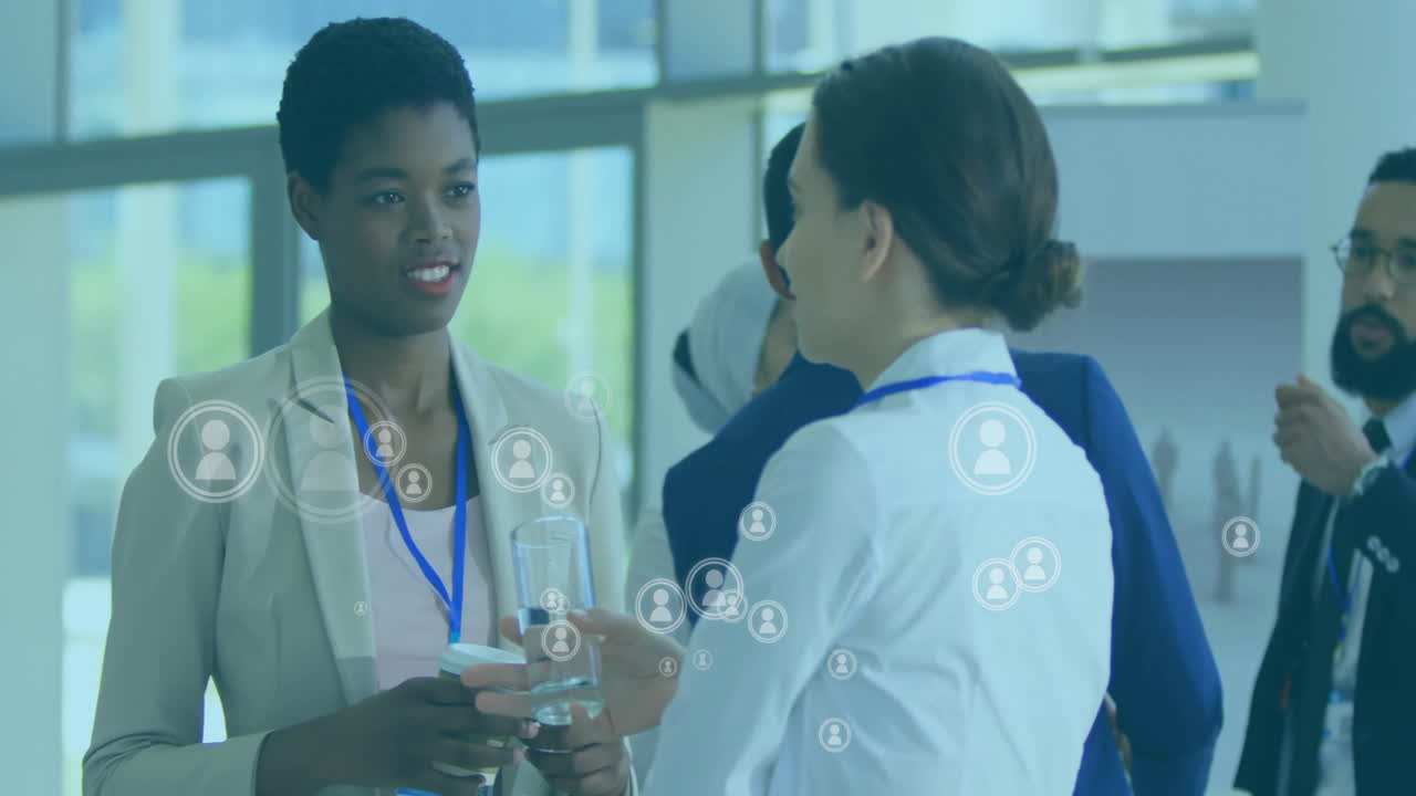 Animation of people icons over diverse business people in office
