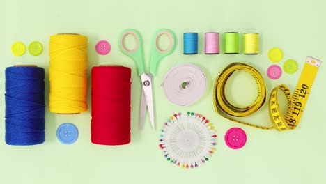 sewing and knitting threads and other items ordering on green theme. stop motion