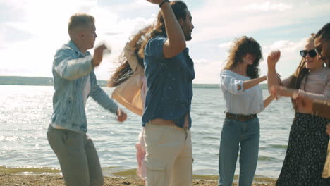 friends dancing at the beach