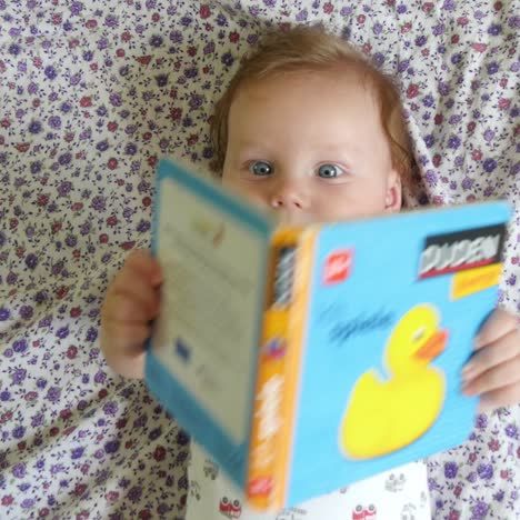 baby playing with story book