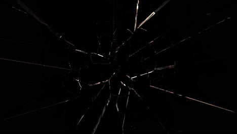 glass exploding outwards from center on black background. shatter effect, impact, destruction concept for dynamic visuals or transitions