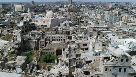 buildings of aleppo in syria 10 years after the civil war. we can see grass covering ruins of building, destroyed after bombing - aerial view 4k