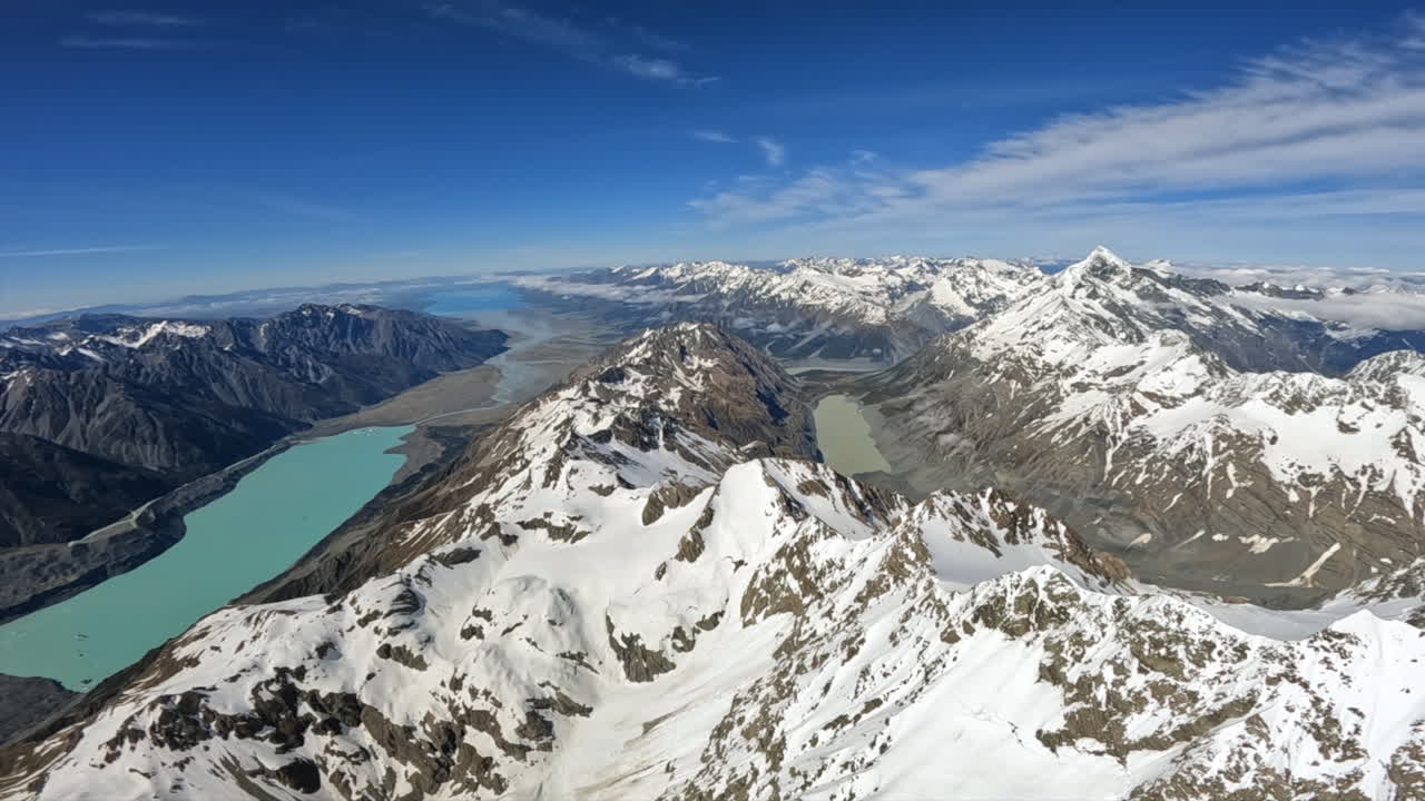 POV helicopter flying down from Aoraki mount cook summit with the Tasman Lake and Lake Pukaki visible, Southern Alps New Zealand