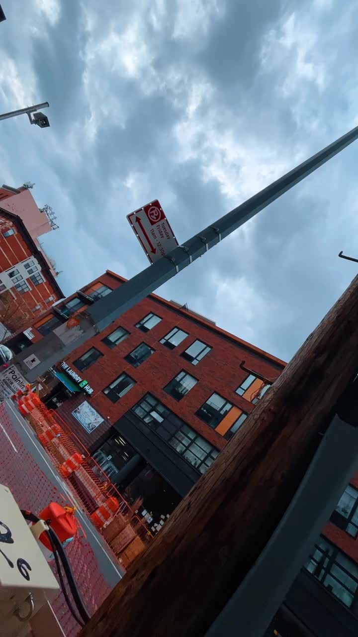 Low angle view of electrical wires and urban buildings. Looking up at utility poles with complex wiring and equipment between modern residential apartment blocks
