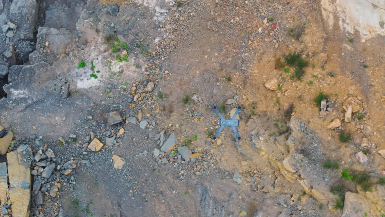 Aerial top down view of unmanned drone fly above rocky surface, Czechia