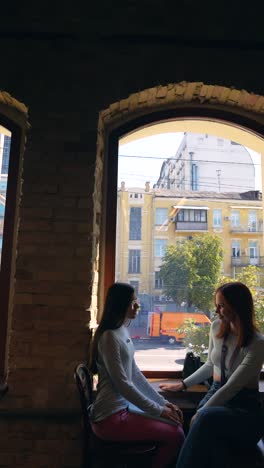 two women talking in a cafe