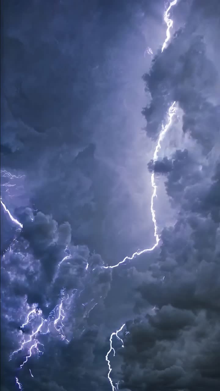 Dramatic video of lightning striking through dark storm clouds, captured from a low-angle