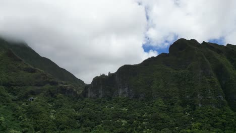 drone rise between verdant ridges, big island, hawaii