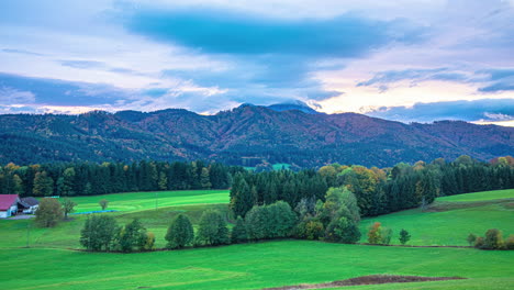 autumn countryside view with green meadows and mountain in background