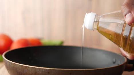 pouring oil into a pan