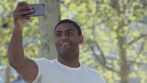 Happy-African-American-man-recording-video-with-smartphone.